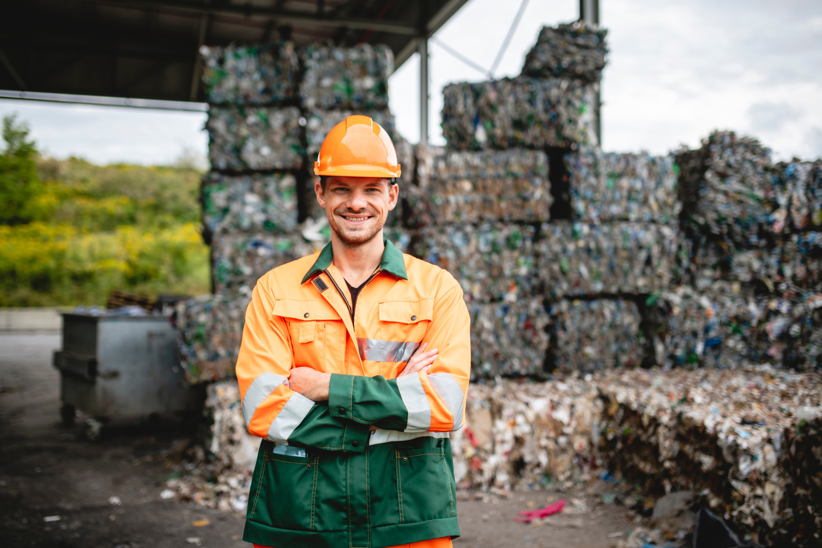 Smiling Workman Outdoors at Waste Management Facility